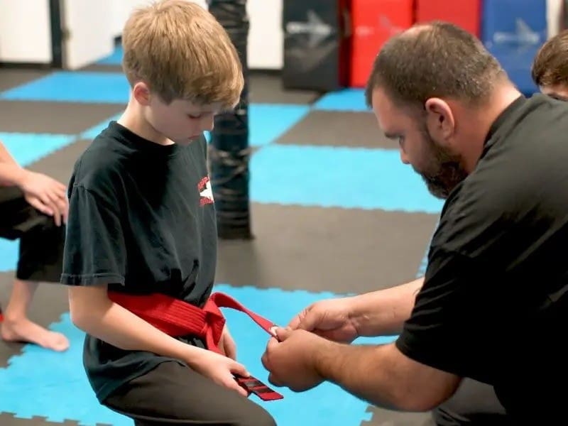 instructor guiding students through martial arts drills for discipline