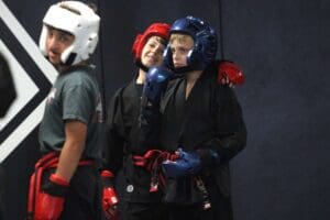 Students wearing sparring gear practicing together during training as karate belt levels explained through skill progression and consistent practice.