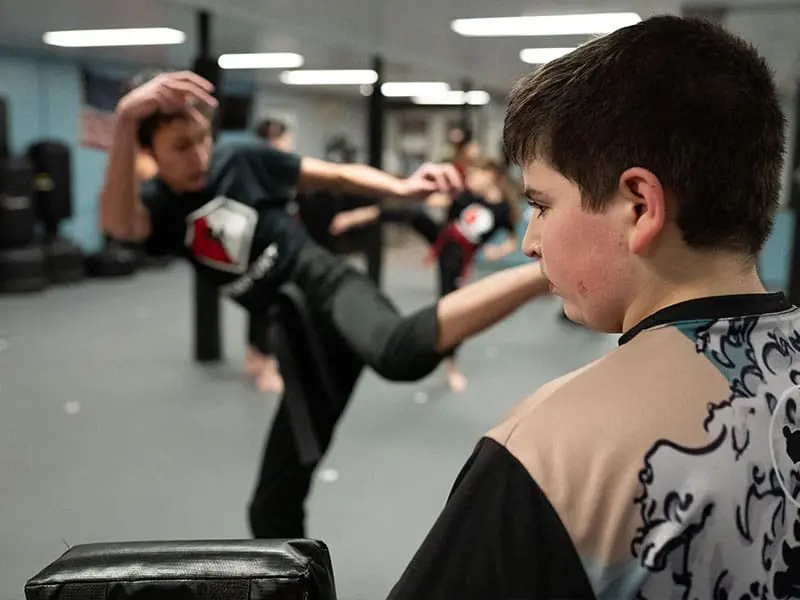 students practicing moves for teens self defense classes