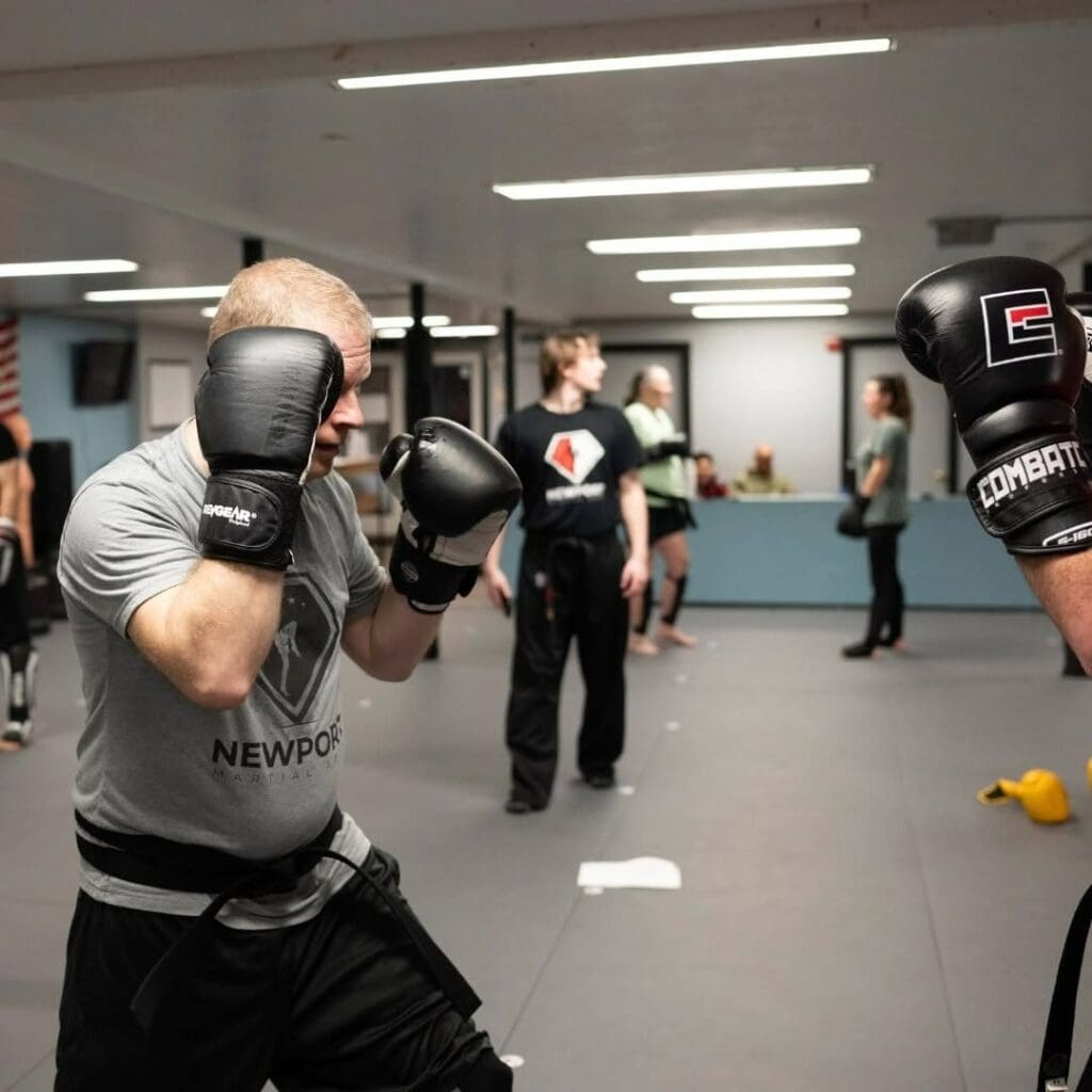 Adult student practicing guard and striking distance with a partner during self-defense training, what you learn in self defense lessons